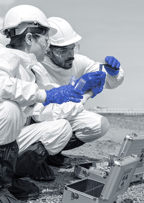 two people in safety gear mixing chemicals